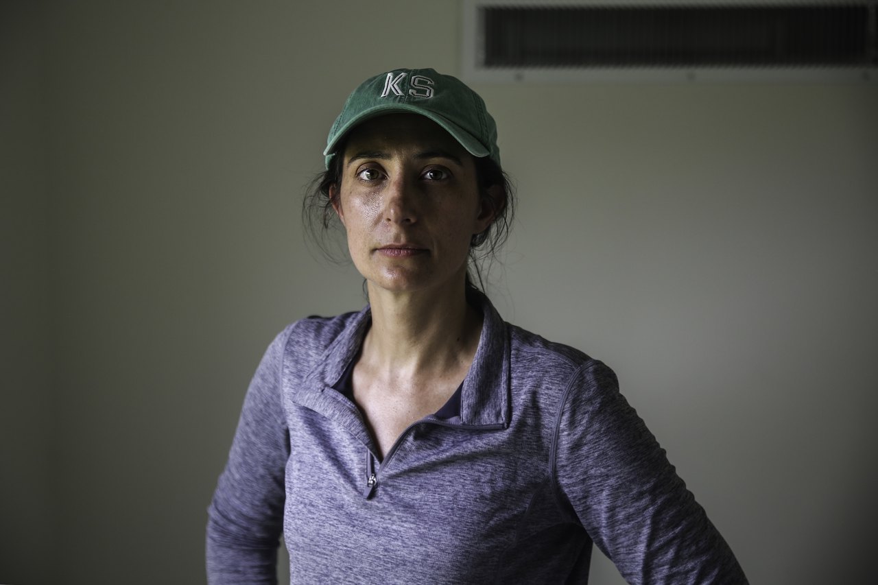 A woman in a green baseball cap