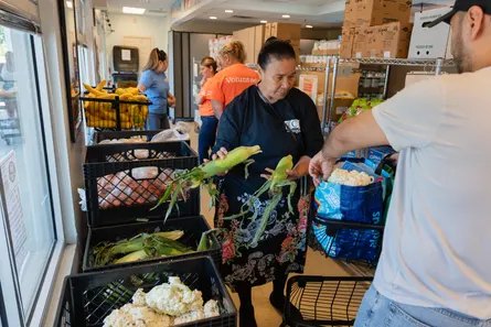 People packing food into a bag
