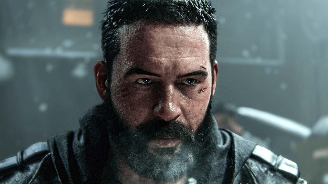A character from Call of Duty Modern Warfare 4. The soldier has short dark hair and a beard with scars above his left eye. He has a serious expression as snow falls behind him in a darkened backdrop.