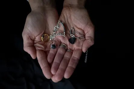 close-up of hands holding jewelry