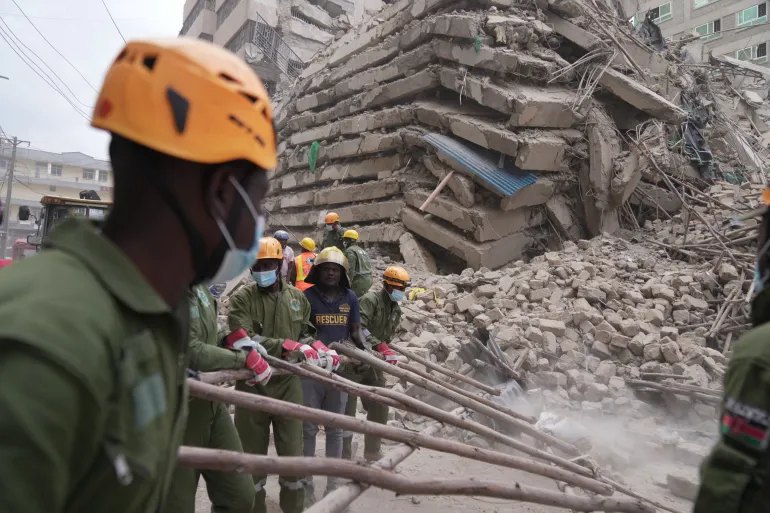 Security forces and civil defense work after a multi-story building collapsed in Nairobi, Kenya, Friday, Oct. 23, 2026. (AP Photo/Brian Inganga)