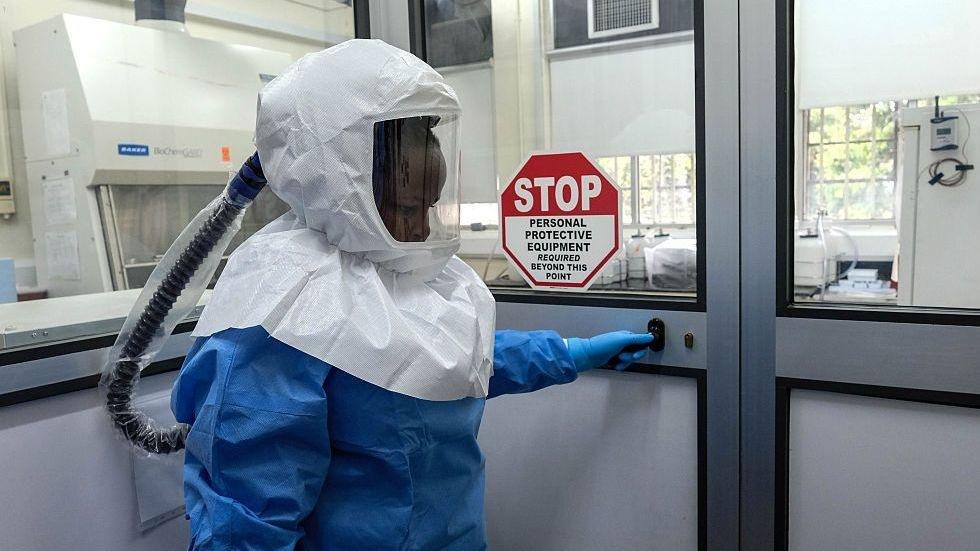 A laboratory technologist wearing protective equipment as she prepares to enter the Viral Hemorrhagic Fever Laboratory at Uganda Virus Research Institute in Entebbe, Uganda