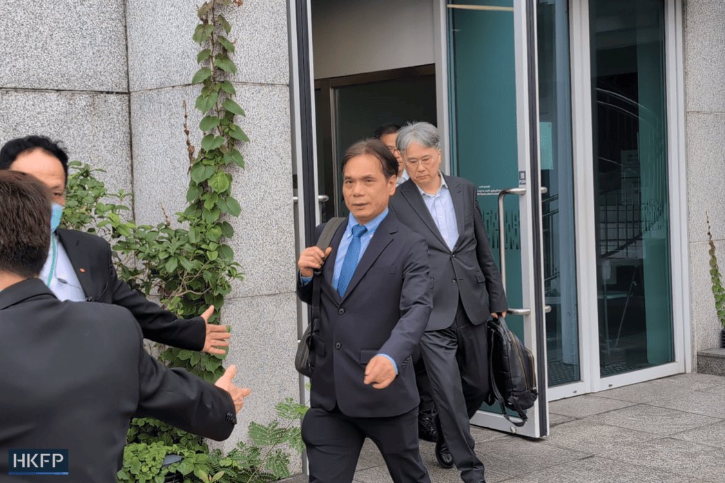 Andy Ku (centre), a senior maintenance surveyor at the Independent Checking Unit (ICU), leaves the Wang Fuk Court independent committee hearing on May 6, 2026. Photo: James Lee/HKFP.