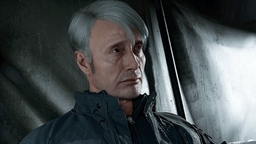 A still from Modern Warfare 4 showing a greying male character wearing a dark zip-up jacket. He's pictured looking solemn in a tent.