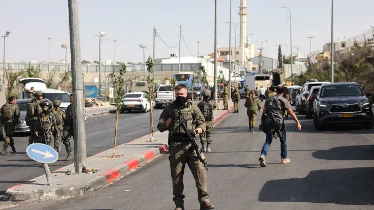Israeli soldiers gather at the scene of an earlier fire exchange between armed Palestinians and Israeli forces following an incident at the norther checkpoint of Hebron in the Israeli-occupied West Bank on October 23, 2026.