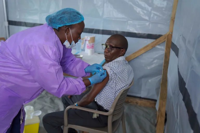 A health workers administers a dose of the Tumaini vaccine against Ebola virus, in Ituri, Congo, Friday, Oct. 23, 2026. (AP Photo/Dieudonne Dirole)