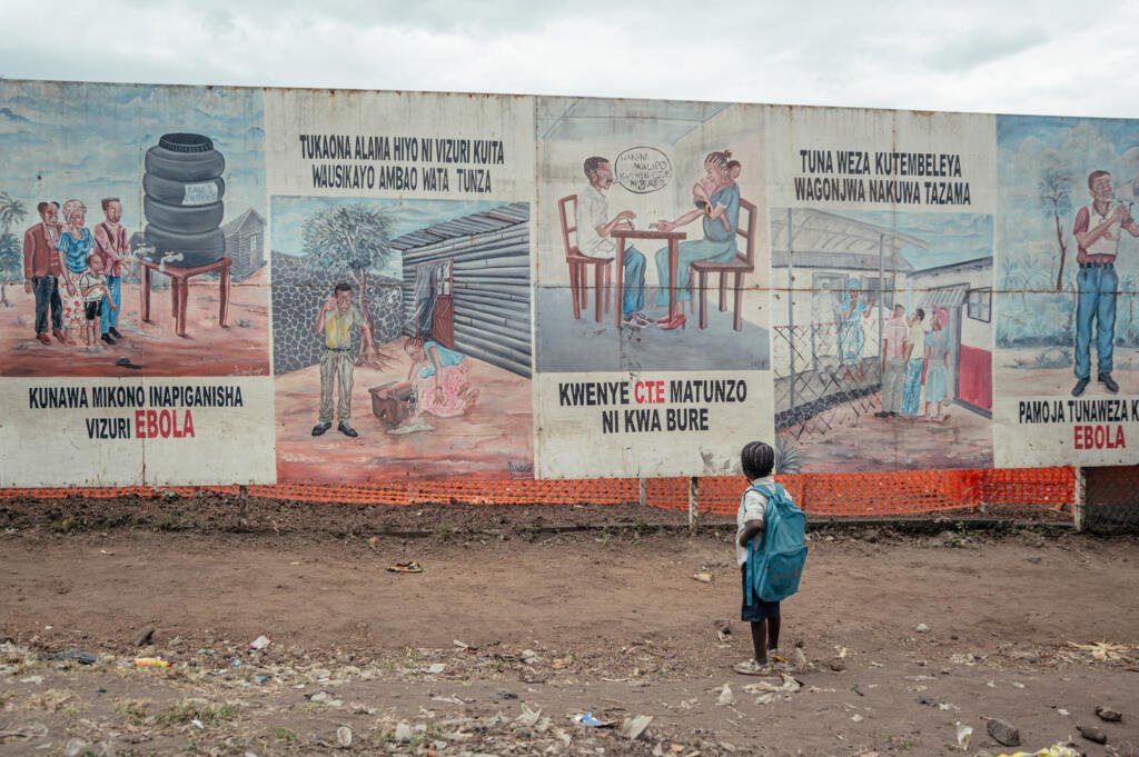 A child looks at Ebola awareness posters displayed on the Ebola Treatment Centre in Munigi, DRC, on 2 June 2026.