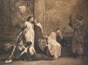 A sepia photograph, titled The Mystic Sign, shows women in saris watching a turbaned man gesture