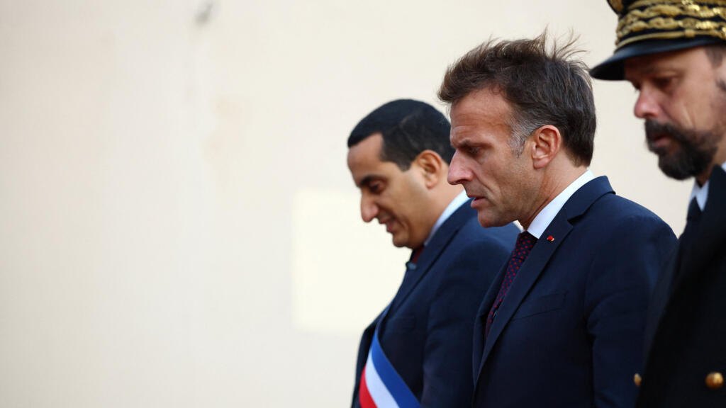 French President Emmanuel Macron walks alongside Mayor Ali Rabeh in Trappes, in the Yvelines department, near Paris, France, October 23, 2026