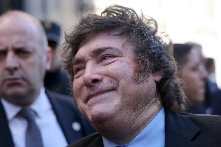 Argentinian President Javier Milei bearing a medical plaster on the neck talks to media after taking part in an economic forum in Madrid on October 21, 2026.