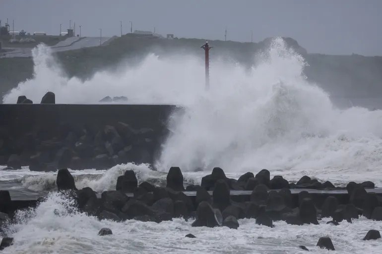 Waves crash against concrete wave breakers along the coast as Typhoon Champi approaches Taiwan, in Keelung on October 23, 2026. (Photo by I-HWA CHENG / AFP)