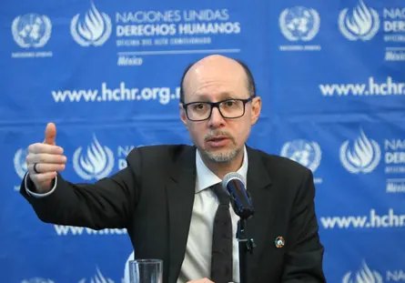 A man gestures while speaking.
